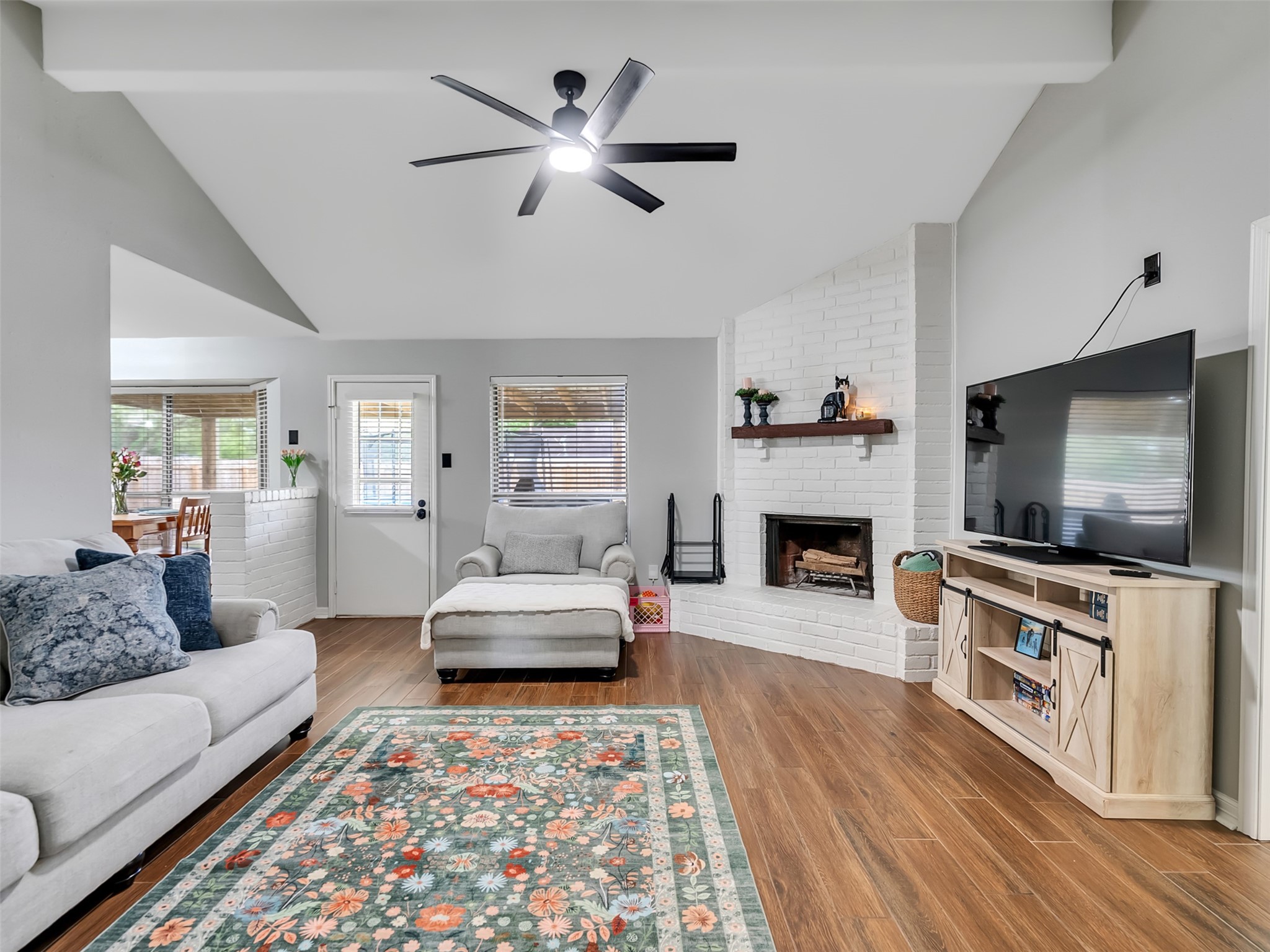 101 North Wagon Lane Angleton, TX 77515 - Photo 3 of 23 a living room with furniture a flat screen tv and a fireplace