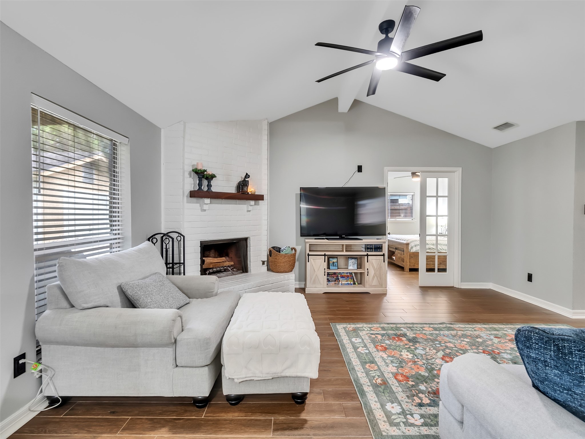 101 North Wagon Lane Angleton, TX 77515 - Photo 5 of 23 a living room with furniture a fireplace and a flat screen tv