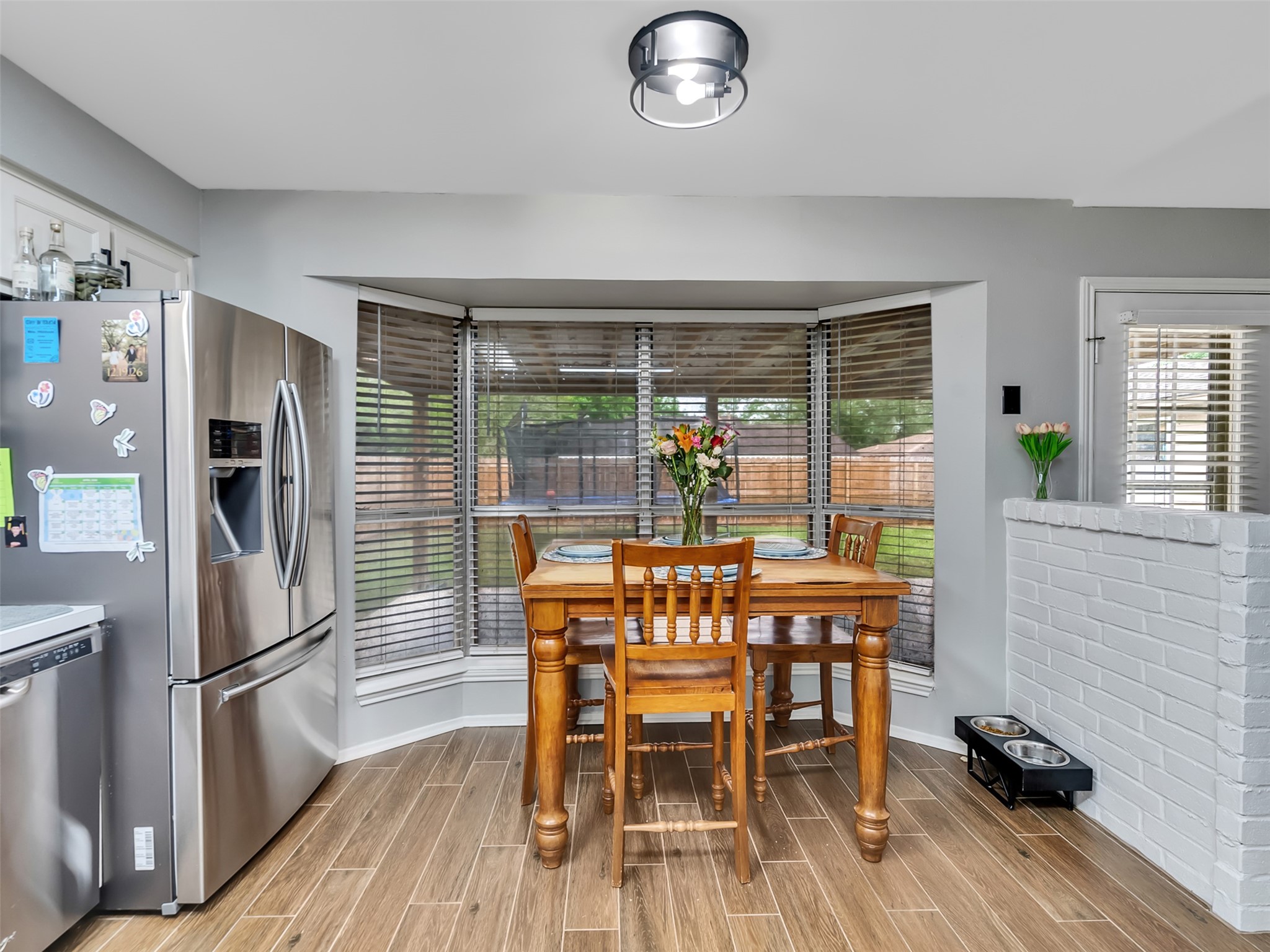 101 North Wagon Lane Angleton, TX 77515 - Photo 8 of 23 a dining room with furniture a window and wooden floor