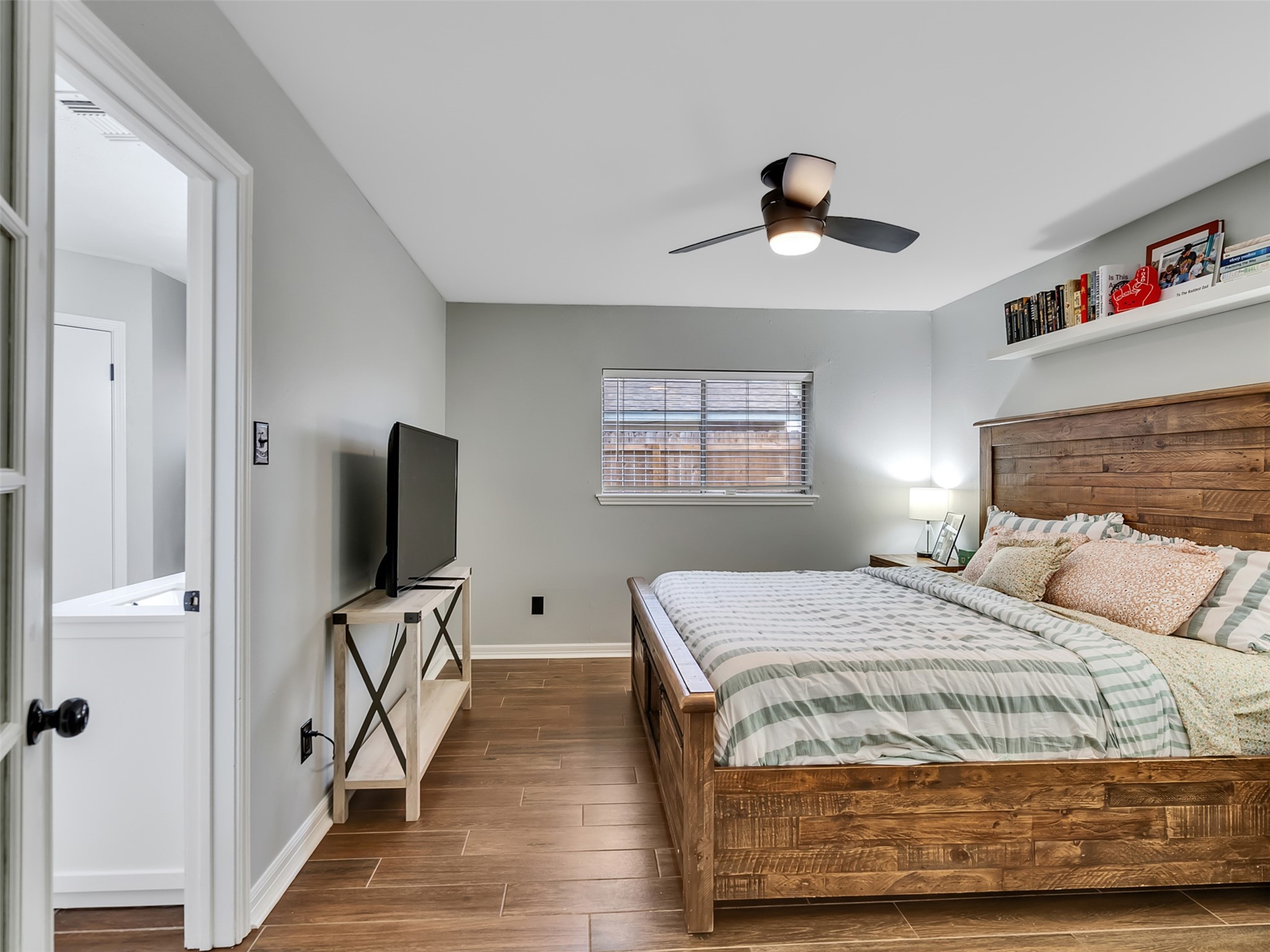 101 North Wagon Lane Angleton, TX 77515 - Photo 10 of 23 a bedroom with a bed and a flat screen tv