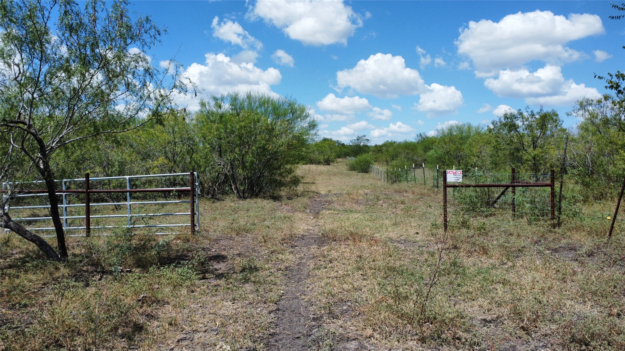 Tbd Pleasant Hl Road Lockhart, TX 78644 - Photo 2 of 8 Mature trees and native grasses border the gated entry to this expansive countryside property.