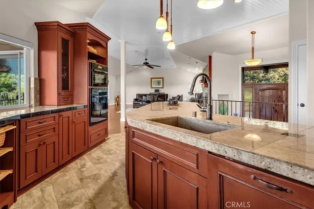 a bedroom with a bed a couch and a chandelier