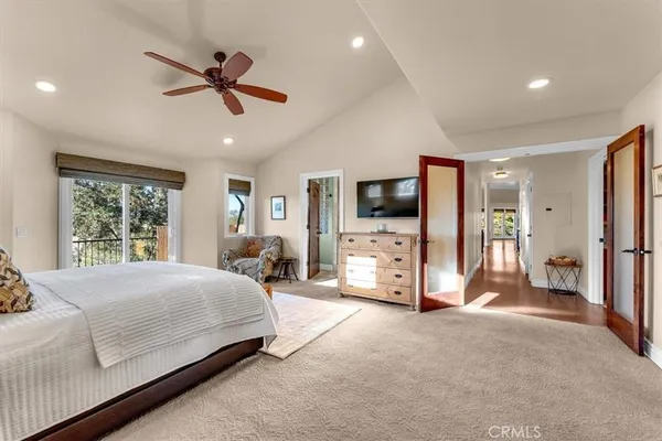 a spacious bedroom with a bed and large windows