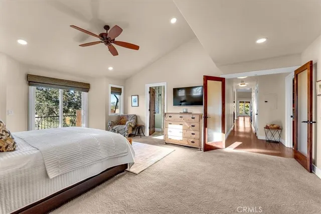 a spacious bedroom with a bed and large windows