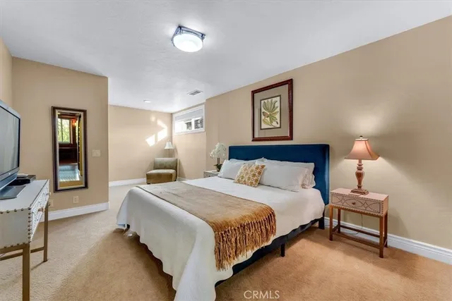 a view of an empty room with closet and a window