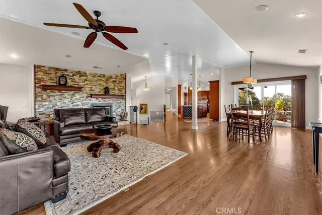 a kitchen with stainless steel appliances granite countertop a table chairs sink and microwave