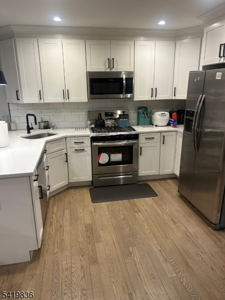 15-17 Rector Avenue Woodbridge, NJ 07095 - Photo 10 of 33 a kitchen with a sink stove and refrigerator
