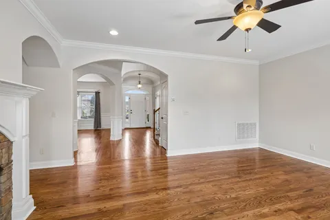 a kitchen with kitchen island granite countertop a sink stove and refrigerator