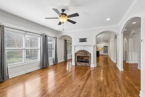 a large kitchen with stainless steel appliances kitchen island granite countertop a large counter top and a stove top oven