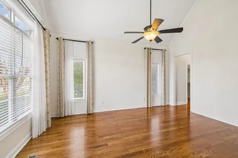 a view of staircase with wooden floor and white walls