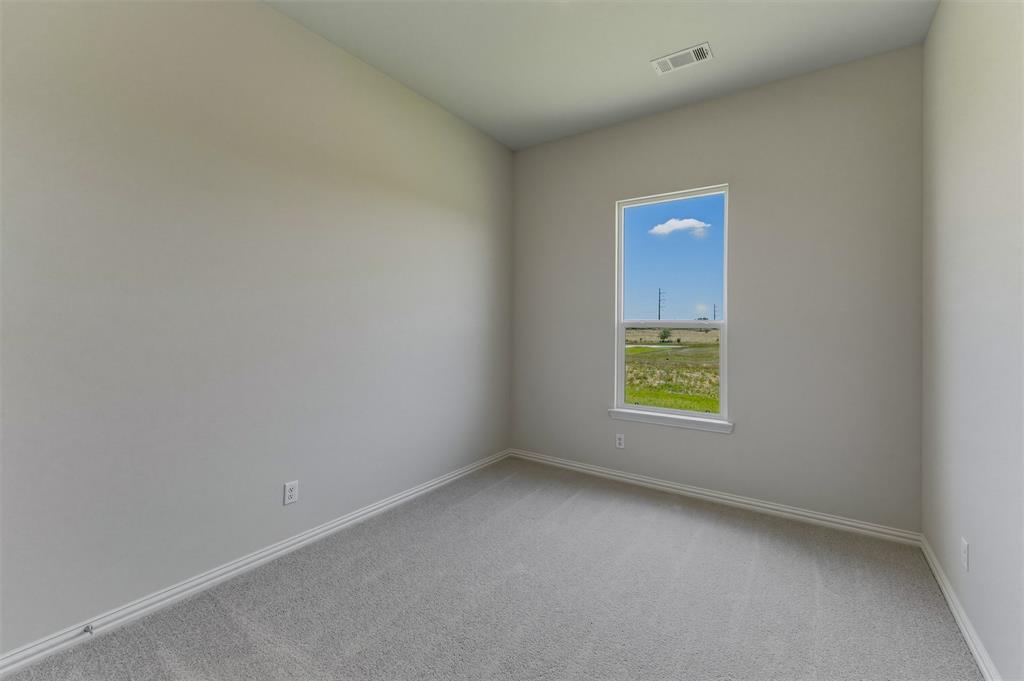 114 Hillview Trail Decatur, TX 76234 - Photo 13 of 27 Room featuring light gray carpet, neutral wall paint, and white baseboards