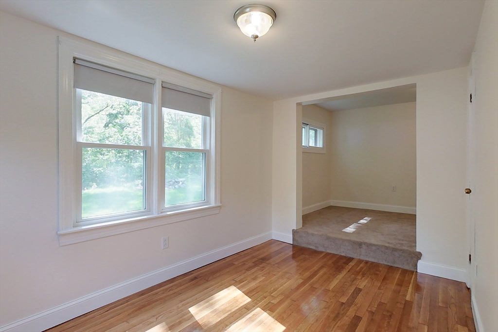 92 Squannacook Road Shirley, MA 01464 - Photo 13 of 38 an empty room with wooden floor and windows