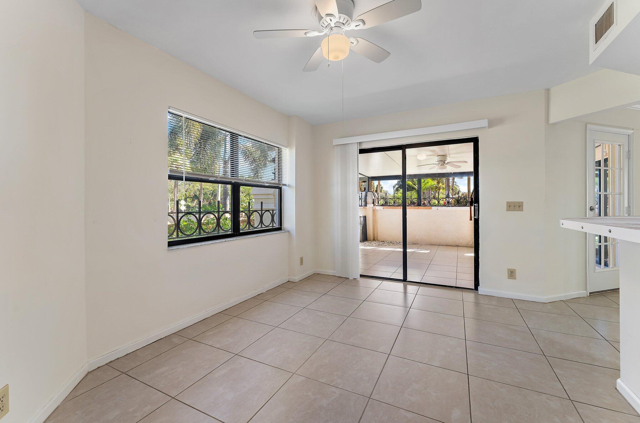 3 Uno Lago Drive, Unit 3 Juno Beach, FL 33408 - Photo 18 of 31 a view of an empty room with window and chandelier fan
