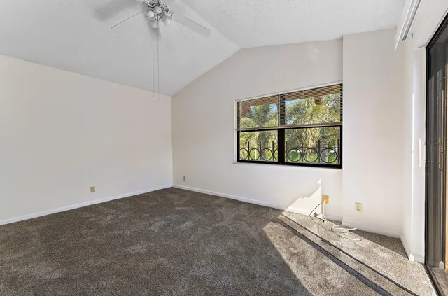 an empty room with sliding glass door and windows