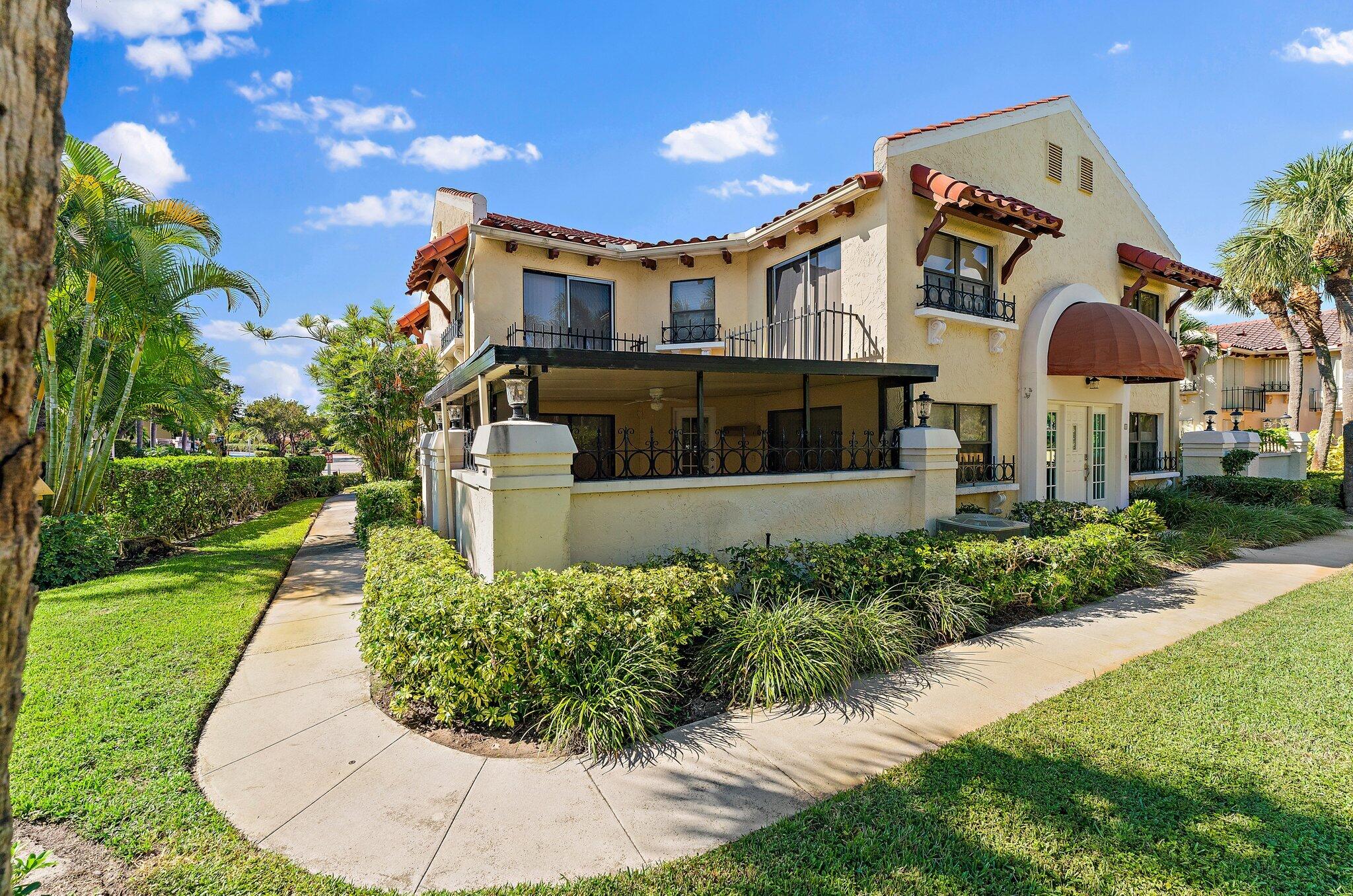 3 Uno Lago Drive, Unit 3 Juno Beach, FL 33408 - Photo 2 of 31 a front view of a house with a yard