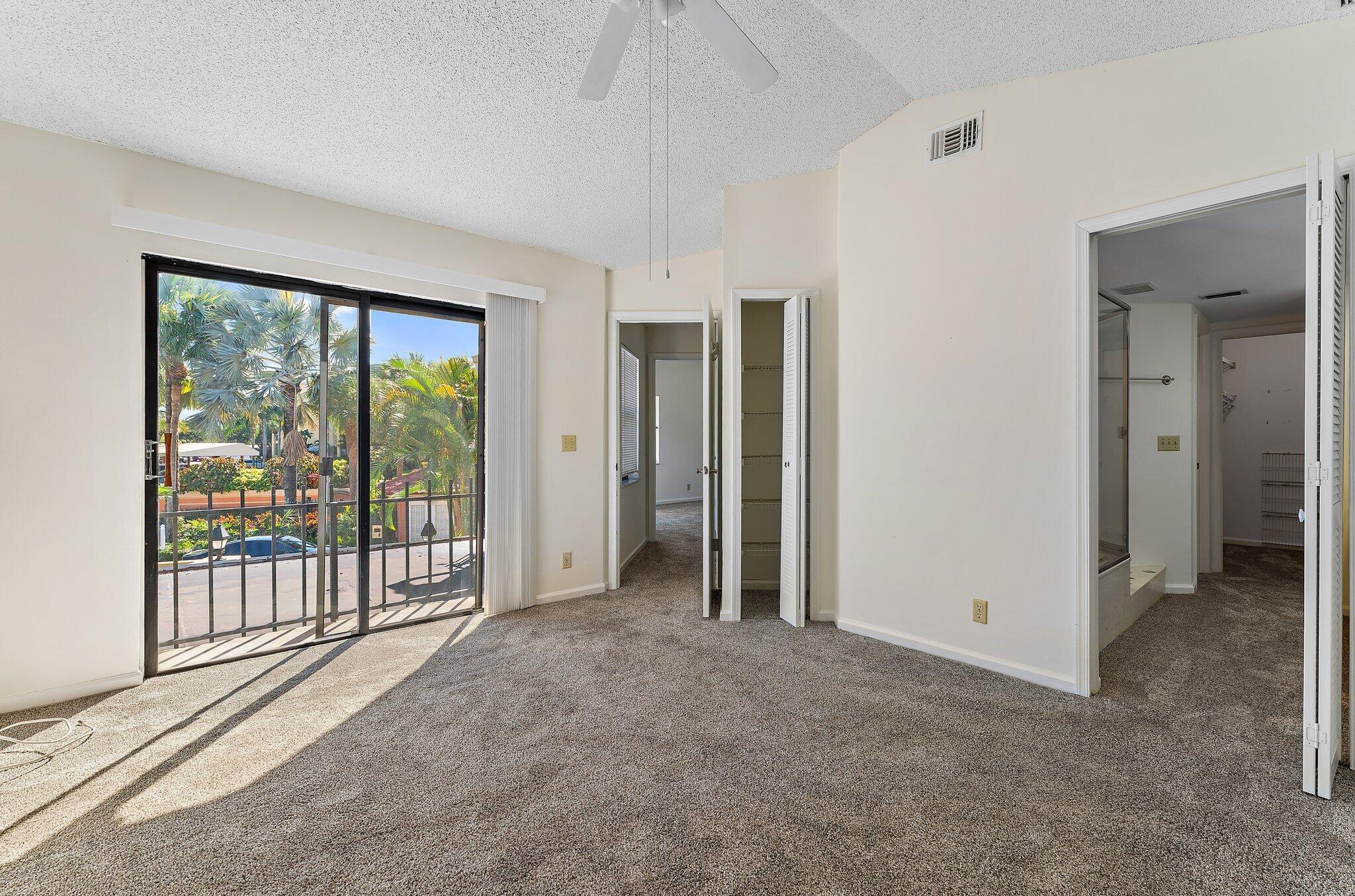 3 Uno Lago Drive, Unit 3 Juno Beach, FL 33408 - Photo 22 of 31 an empty room with sliding glass door and windows