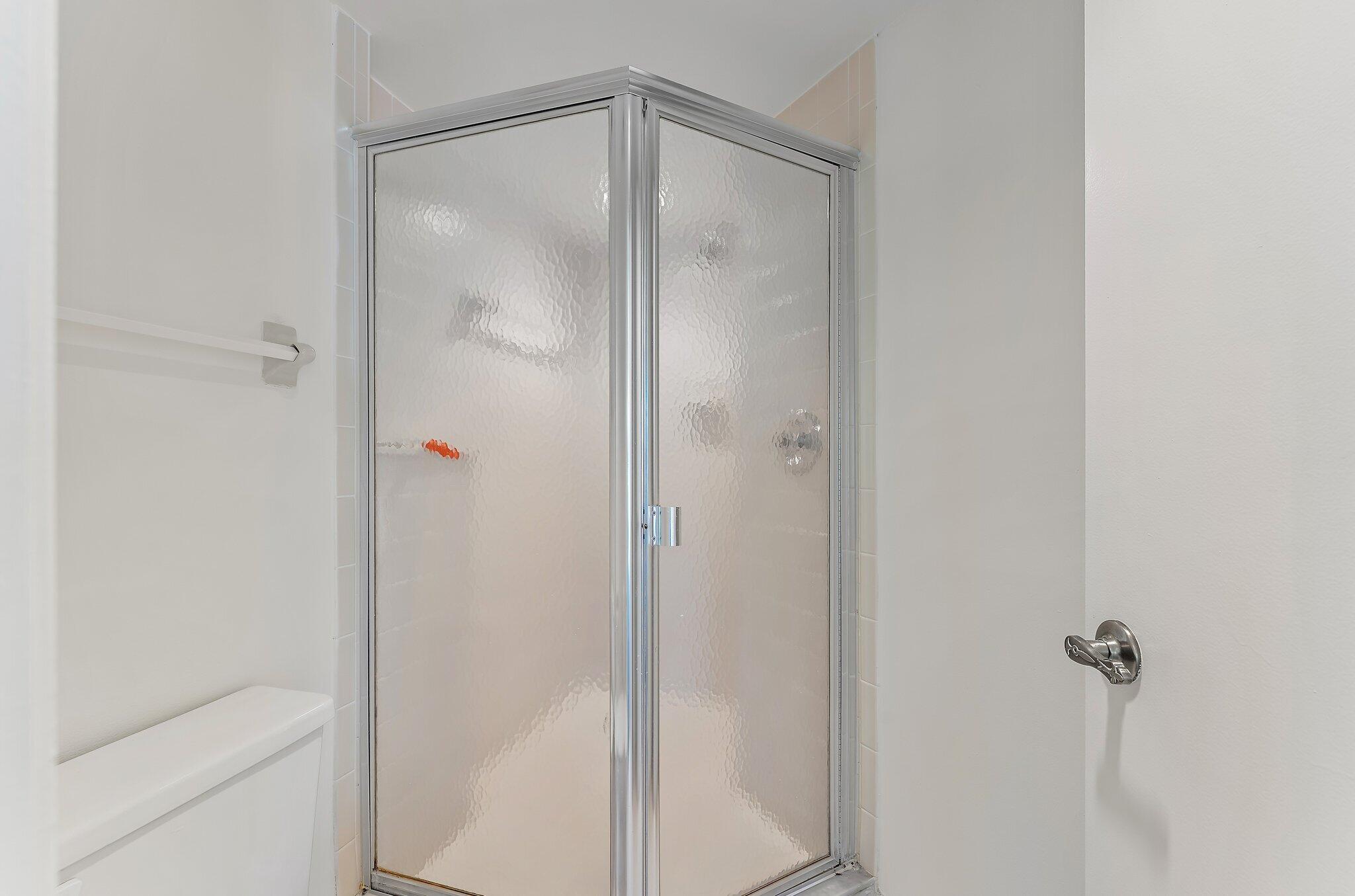 3 Uno Lago Drive, Unit 3 Juno Beach, FL 33408 - Photo 31 of 31 a bathroom with a glass shower door
