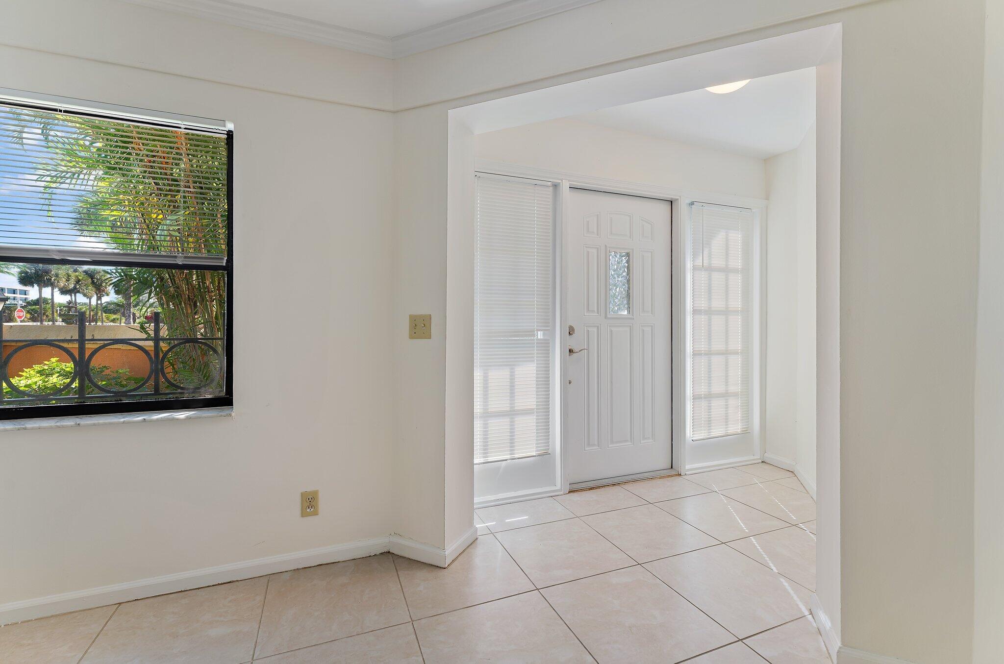 3 Uno Lago Drive, Unit 3 Juno Beach, FL 33408 - Photo 7 of 31 a view of an entryway with wooden floor