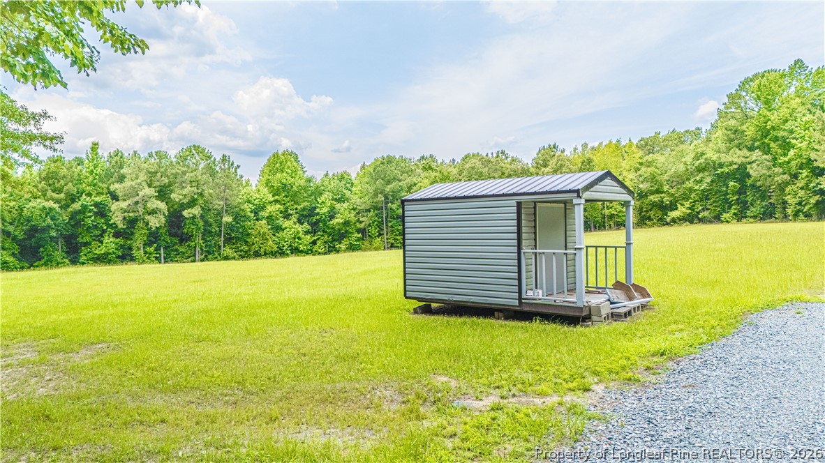 140 Hardy Road Carthage, NC 28327 - Photo 6 of 6 a view of a house with a yard