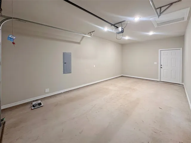an empty room with a ceiling fan and windows