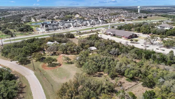 an aerial view of a houses with a yard