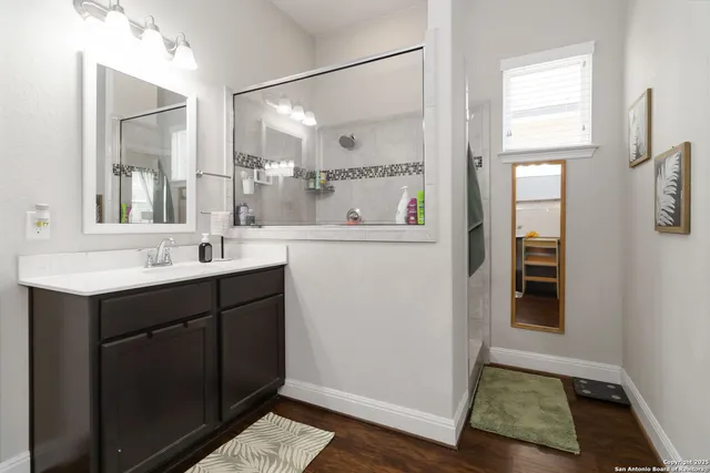 a bathroom with a sink a mirror and a toilet