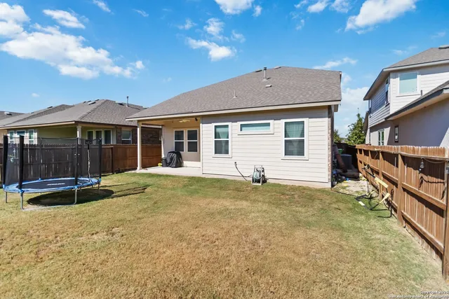 a view of a house with pool and sitting area
