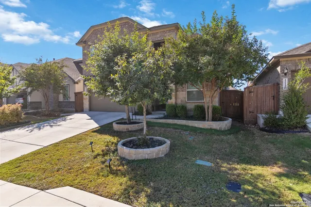 a view of a backyard with plants and patio