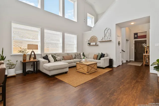 a living room with furniture and a large window