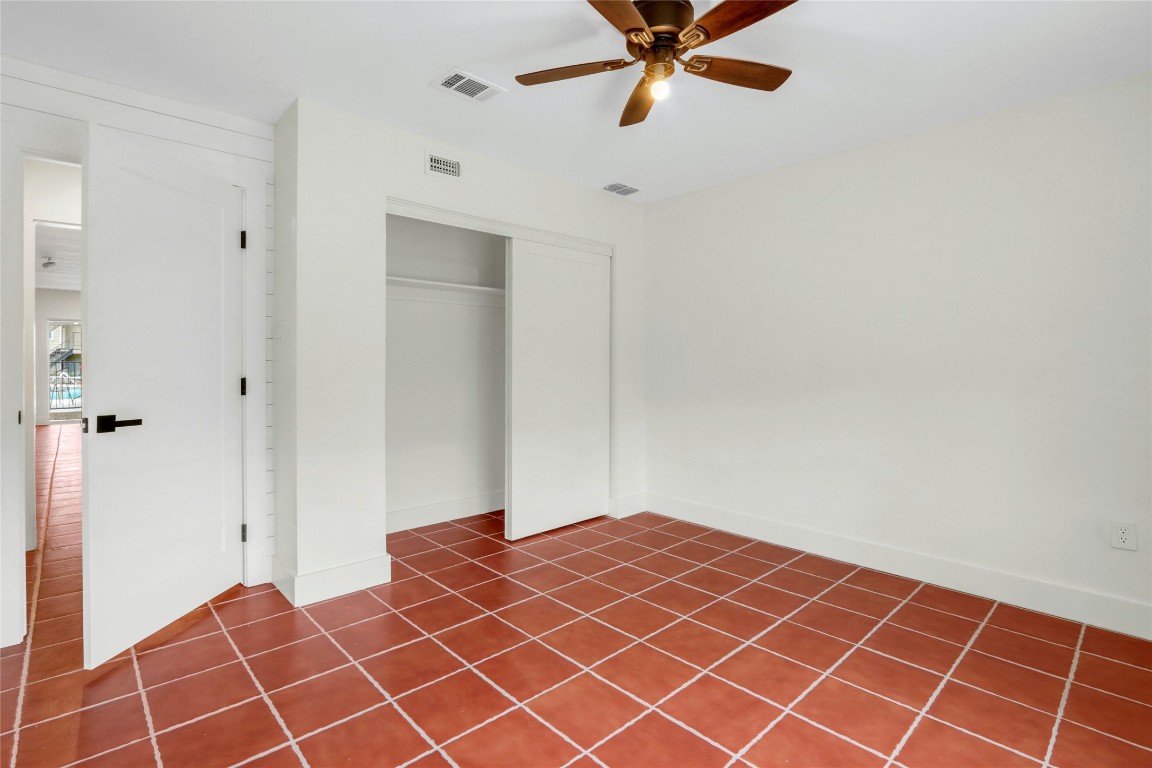 551 Terminal Loop Road, Unit B3 McQueeney, TX 78123 - Photo 18 of 23 a bedroom with a bed and a fan