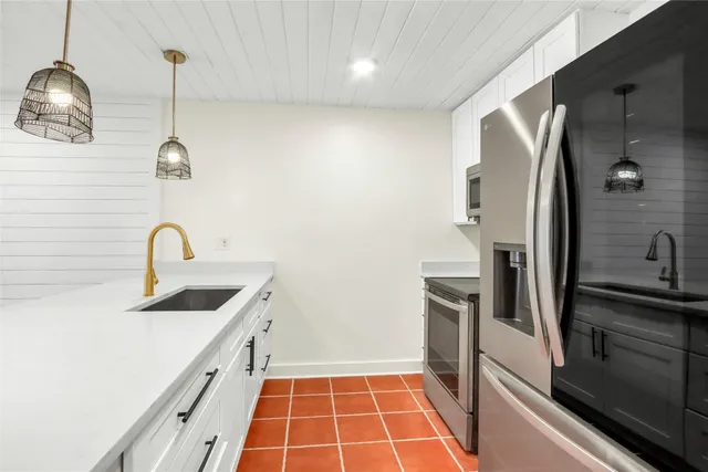 a kitchen with a sink a stove and a microwave