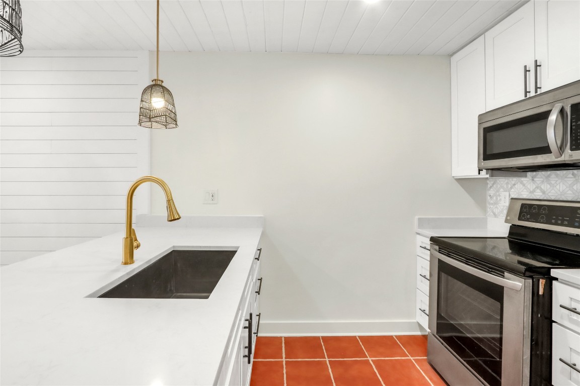 551 Terminal Loop Road, Unit B3 McQueeney, TX 78123 - Photo 9 of 23 a kitchen with a sink a stove and a microwave