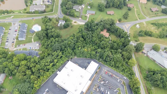 an aerial view of a house with a yard and lake view