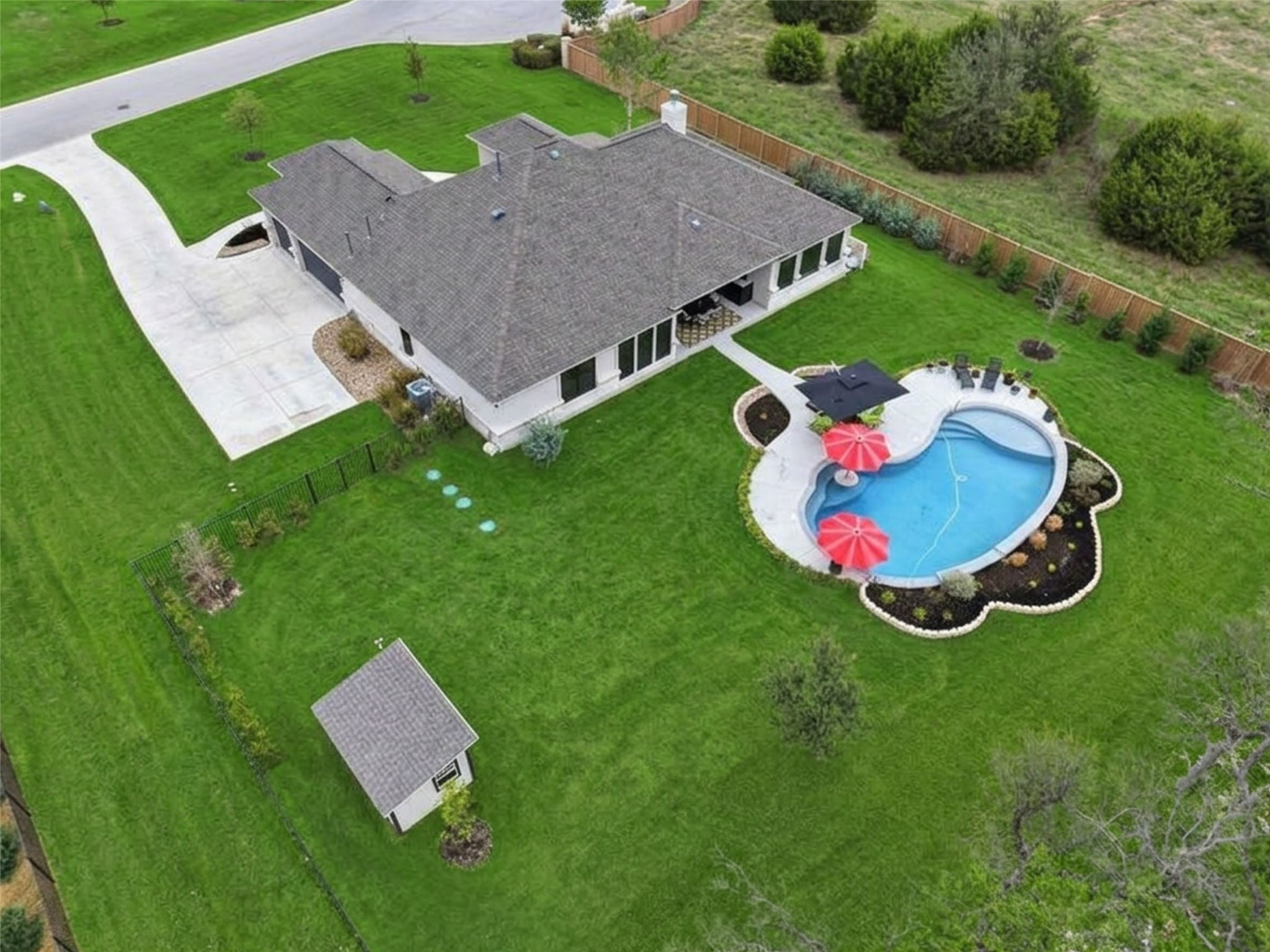 201 Miranda Way Georgetown, TX 78633 - Photo 36 of 37 An aerial perspective reveals a private pool with ample surrounding lawn and a convenient detached storage shed.