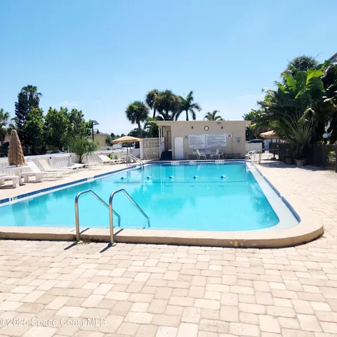 a view of a swimming pool with a lounge chairs