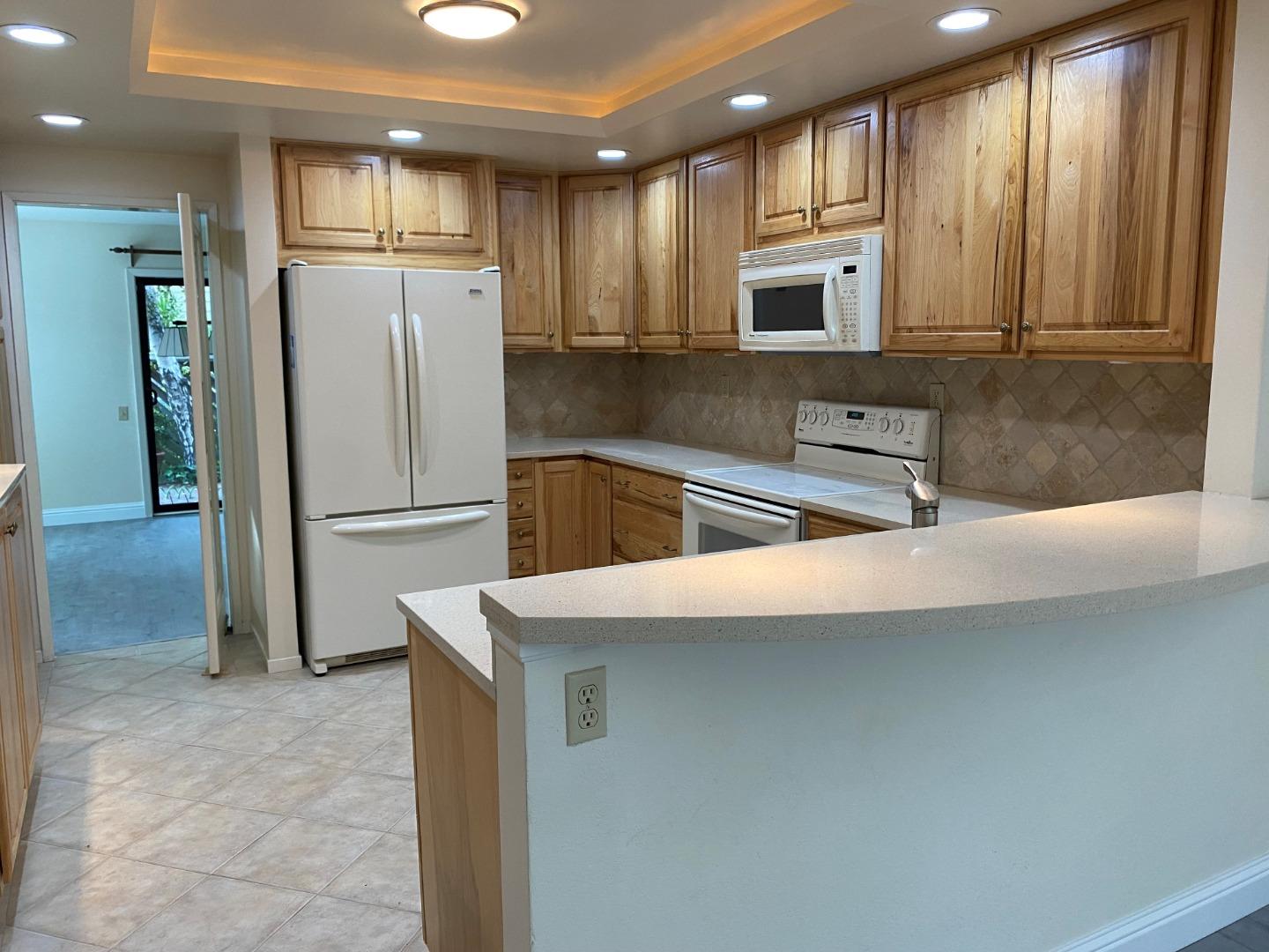 910 Wharfside Road San Mateo, CA 94404 - Photo 2 of 14 a kitchen with a refrigerator and a sink