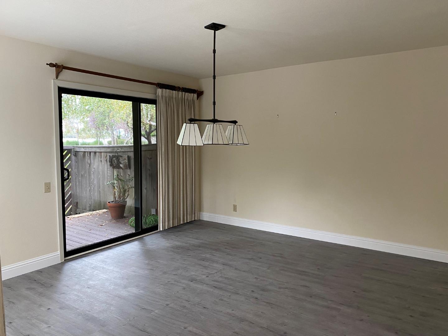 910 Wharfside Road San Mateo, CA 94404 - Photo 4 of 14 a view of empty room with wooden floor and fan