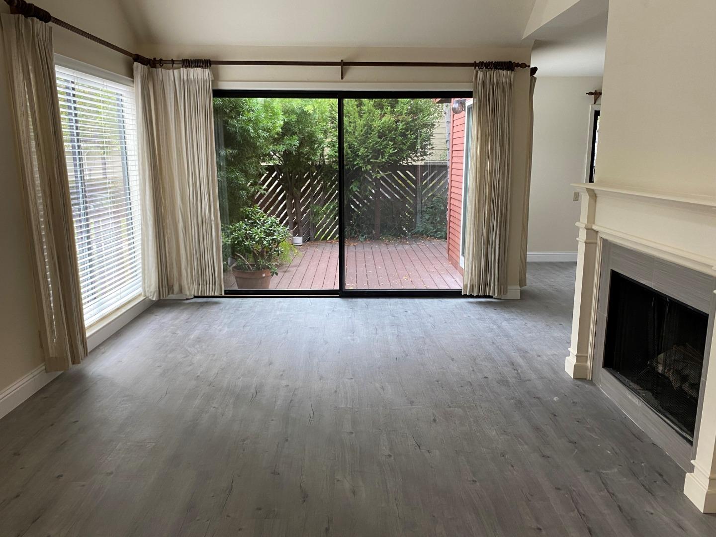 910 Wharfside Road San Mateo, CA 94404 - Photo 5 of 14 a view of a room with wooden floor and a fireplace