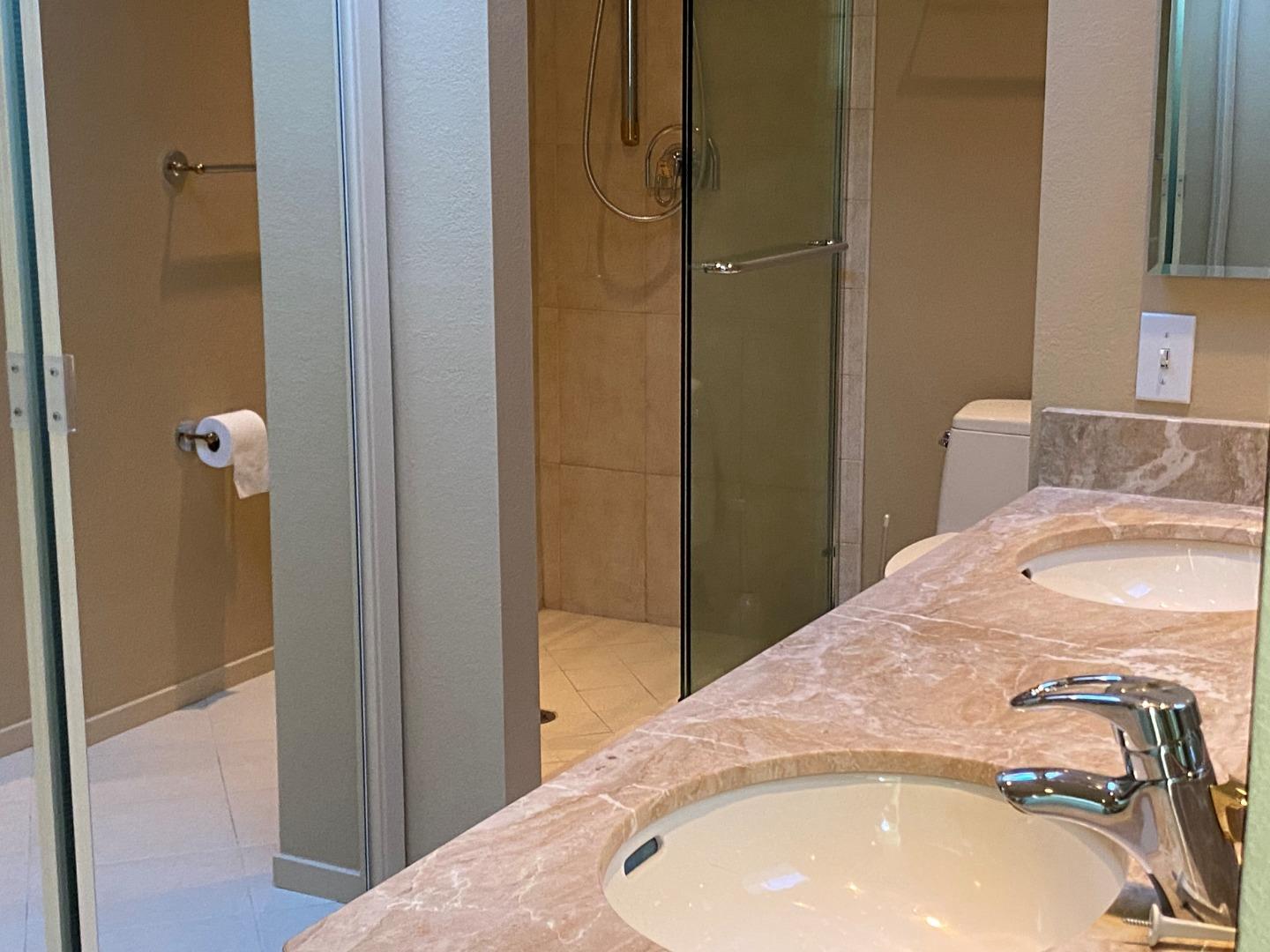 910 Wharfside Road San Mateo, CA 94404 - Photo 8 of 14 a bathroom with a sink and shower