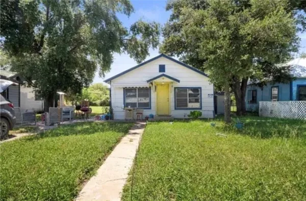 a front view of house with yard and green space