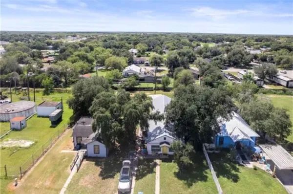 an aerial view of a houses with a yard
