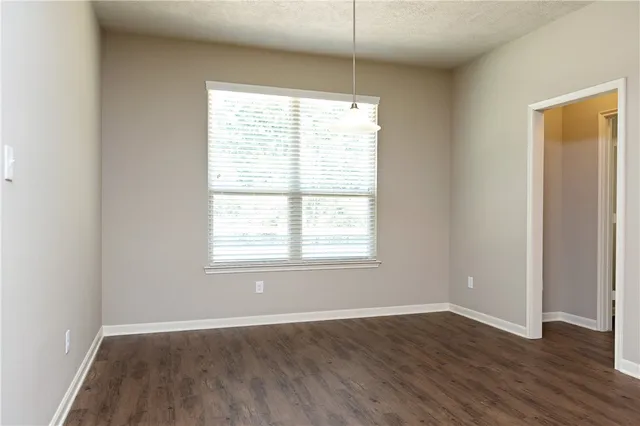 a bathroom with a granite countertop toilet sink and mirror
