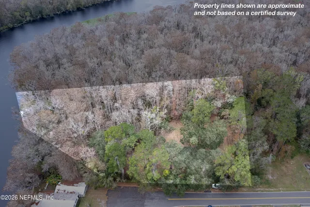 a view of a dry yard with wooden fence