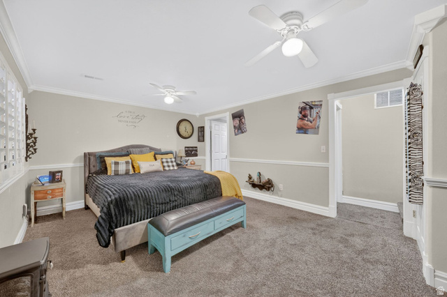 415 East 400 North Santaquin, UT 84655 - Photo 15 of 39 Carpeted room featuring crown molding, chair rail detailing, recessed window with glass block, and a ceiling fan with integrated lighting