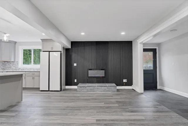 a view of a room with wooden floor and a window