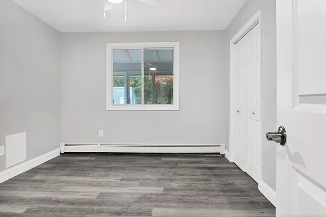 a view of an empty room with wooden floor