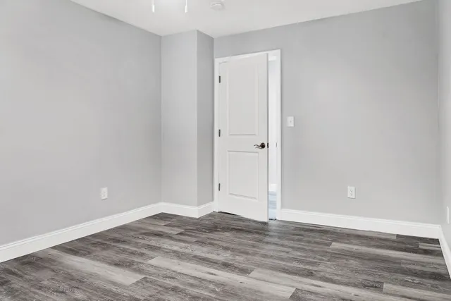 a utility room with a bed and a window