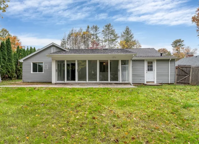 a front view of a house with a garden