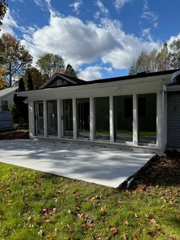 a view of a house with a backyard