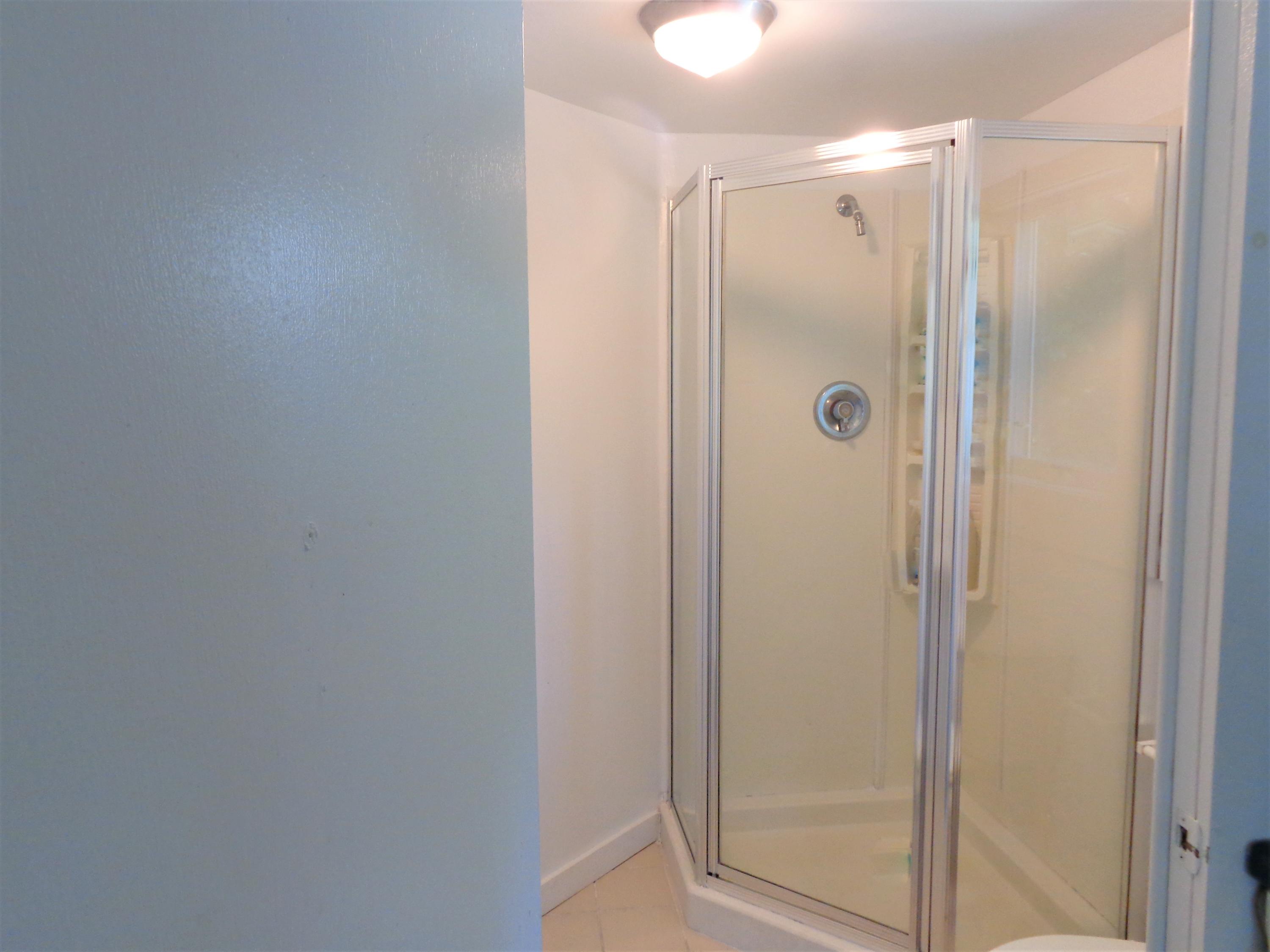 20 Baker Road, Unit C Wellfleet, MA 02667 - Photo 11 of 19 a bathroom with a glass shower door